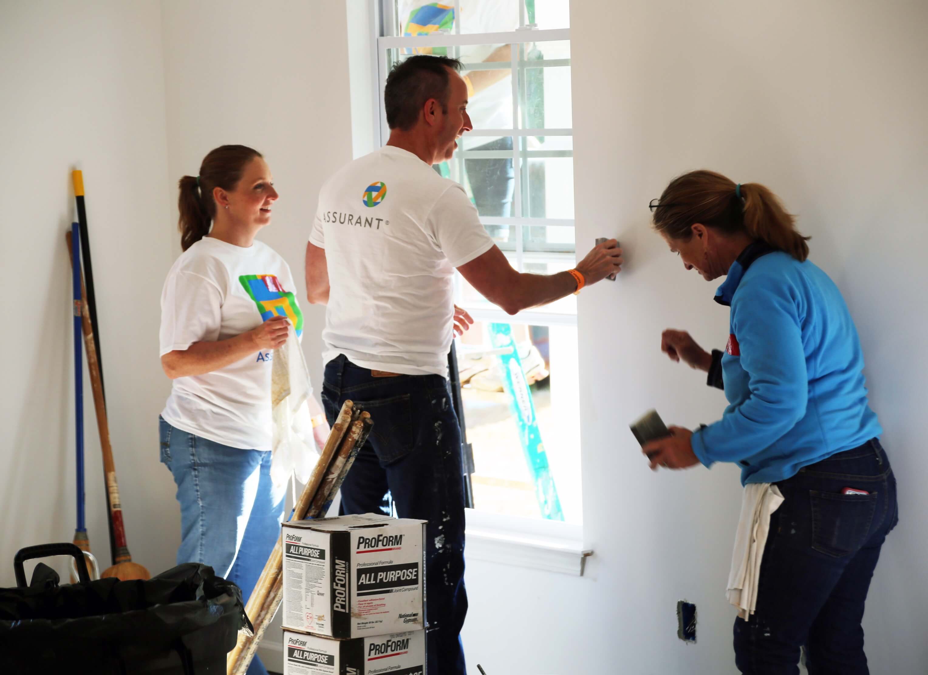 Assurant cares and team member work together to build homes for others