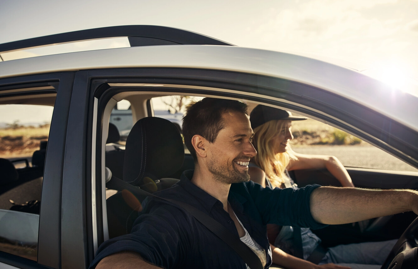 a man and woman sitting in a car